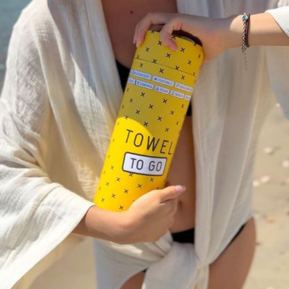 towel to go holding at beach